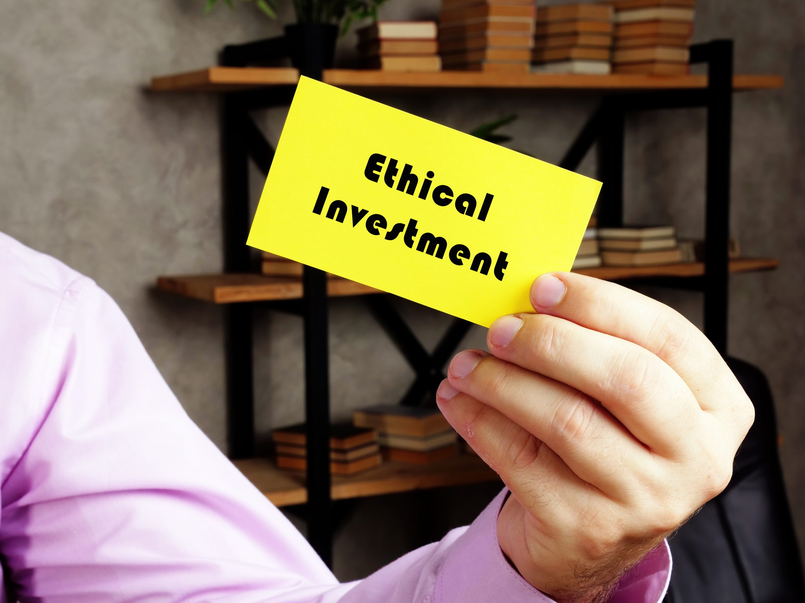 Business concept about Ethical Investment with phrase on the yelow business card.